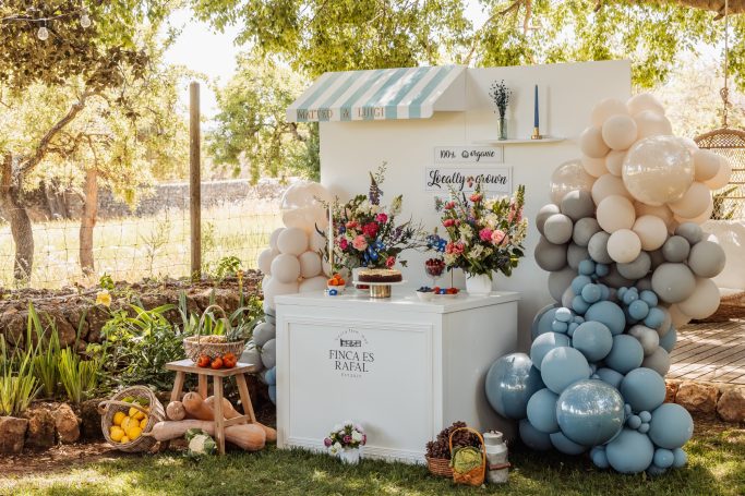 Elegant outdoor party setup with flowers and balloon decor